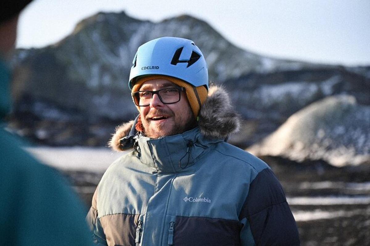 a man wearing a hat and a jacket and a helmet