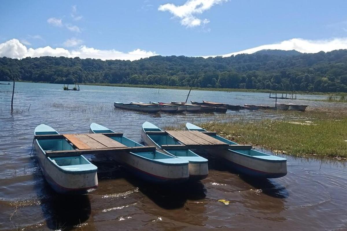a group of boats sitting in the water next to a dock