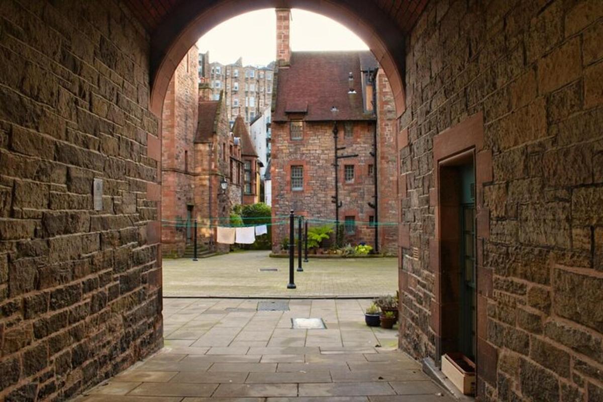 an archway in a brick building with a courtyard