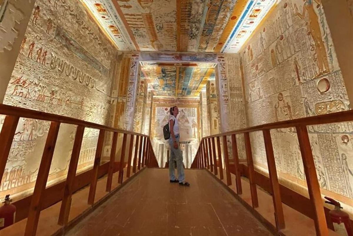 a man standing on a bridge in a room with paintings on the walls