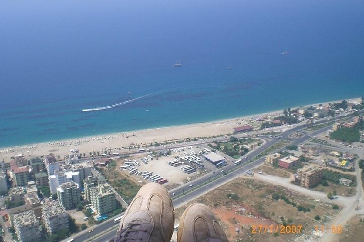 a person standing on top of a building overlooking a beach