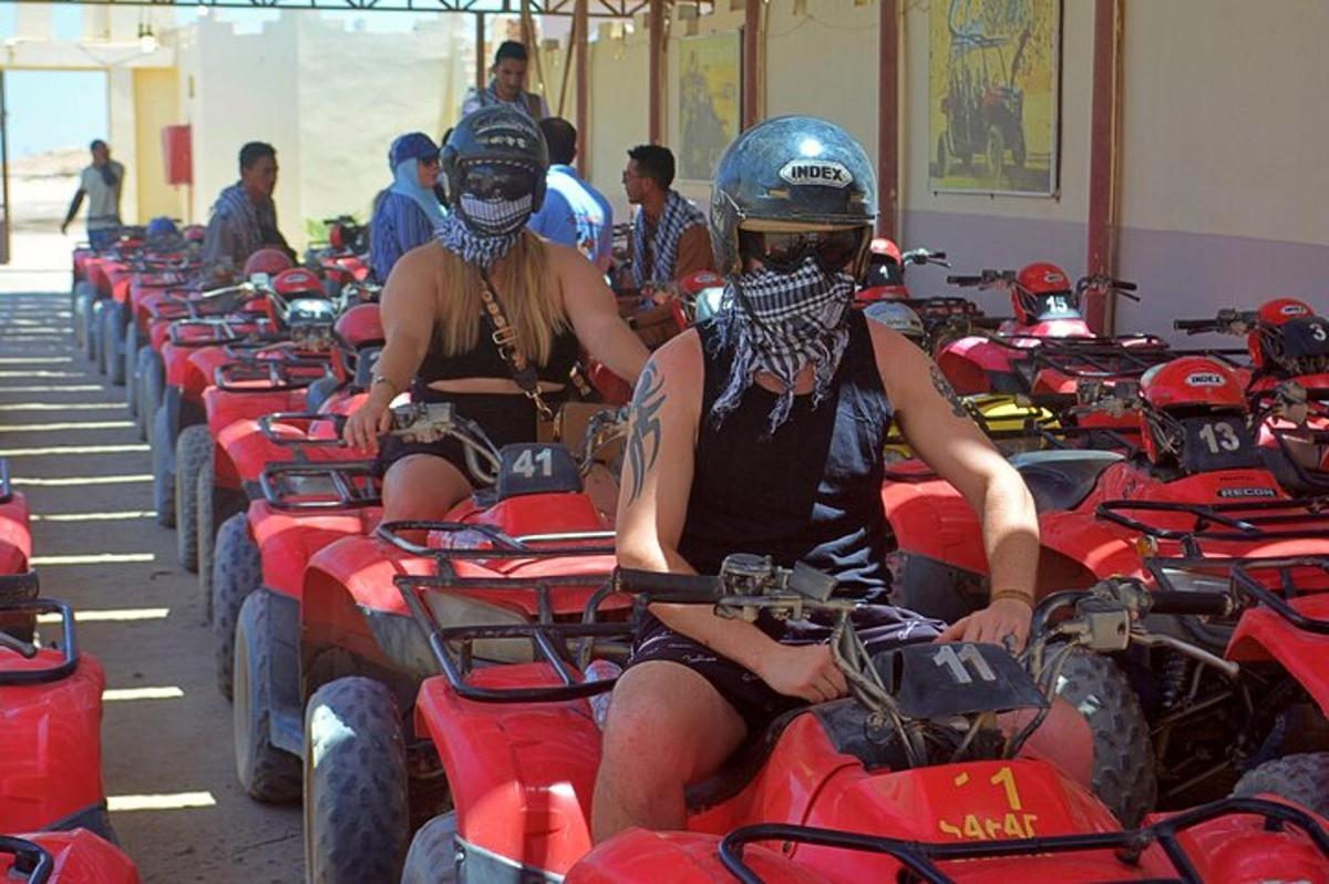 two people are sitting on quad bikes in a room