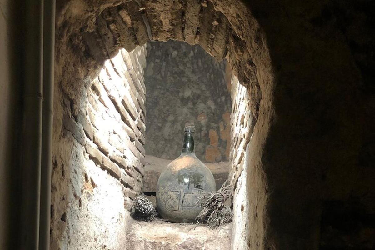 a stone tunnel with a vase sitting on a shelf
