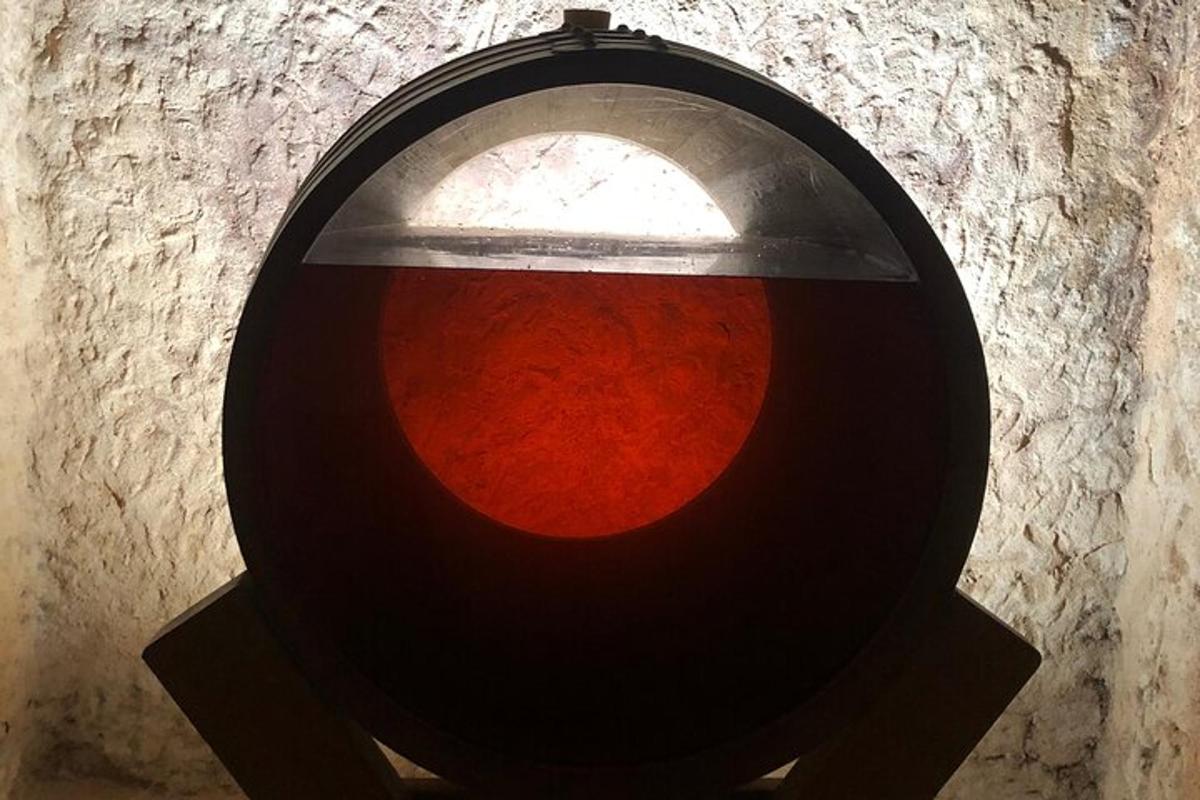 a light hanging from a wall with a red light