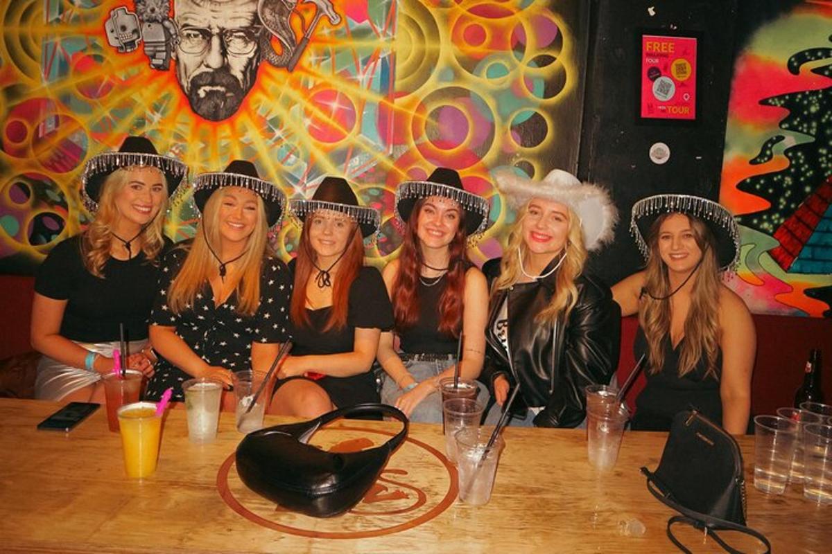 a group of women wearing cowboy hats sitting at a table