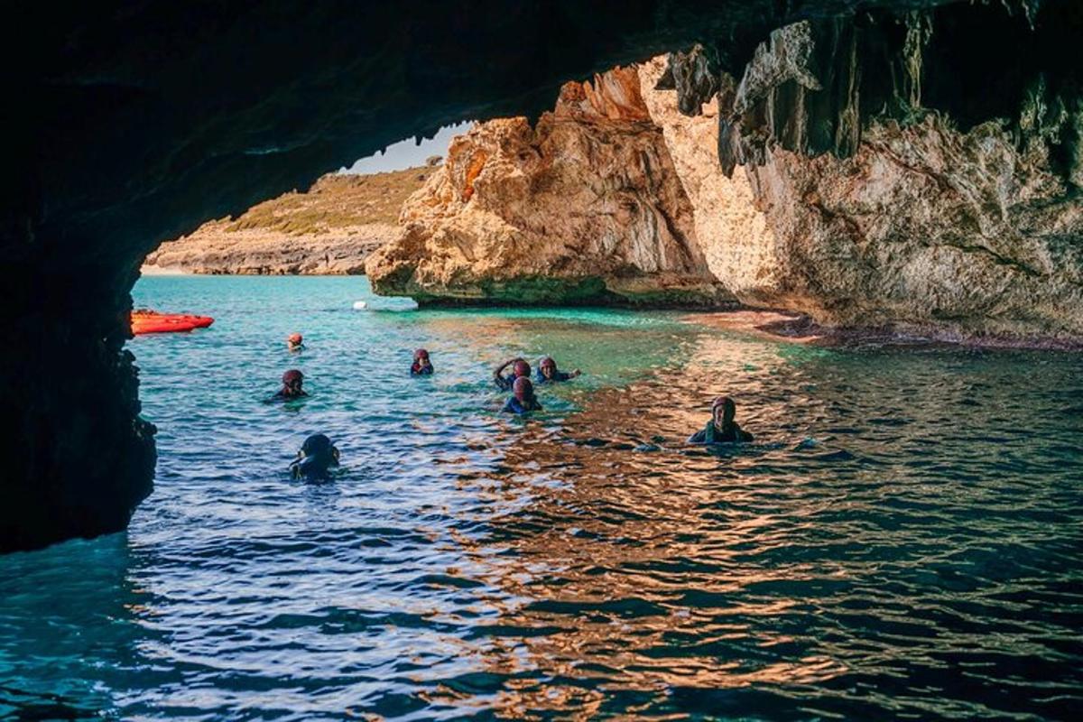 a group of people in the water in a cave
