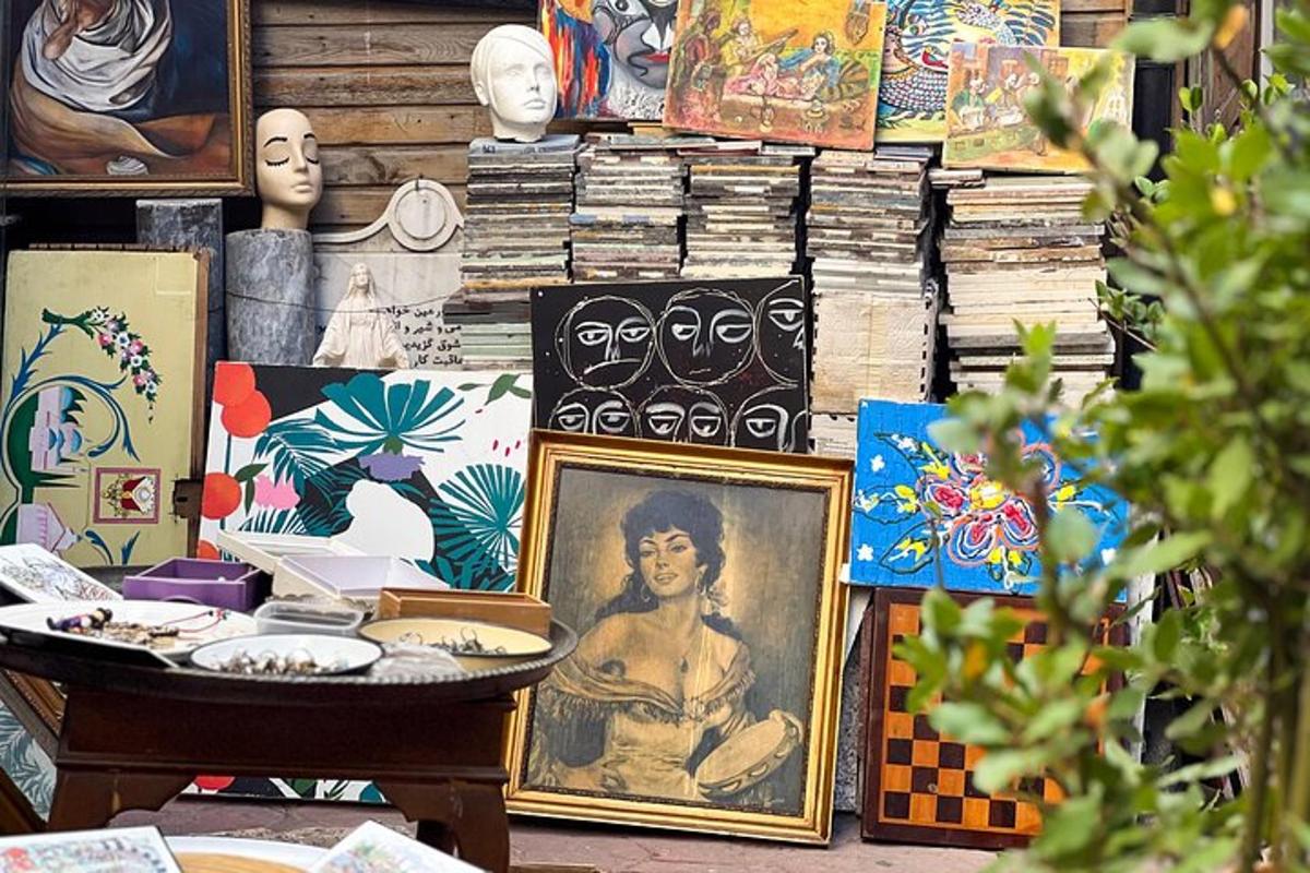 a pile of paintings and other items on a table