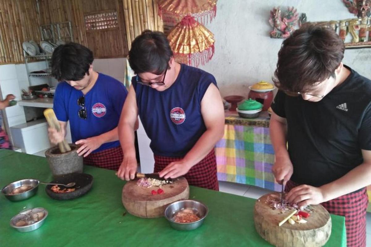 a group of people preparing food in a kitchen