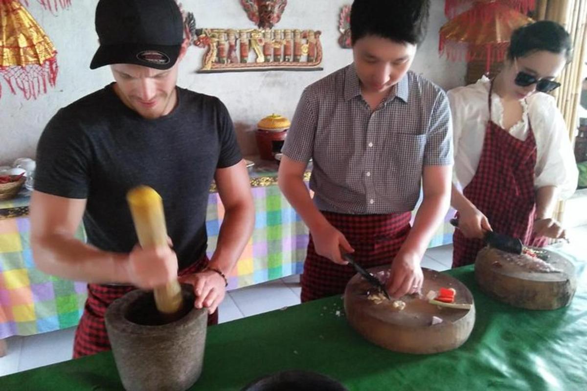 two men are preparing food in a kitchen