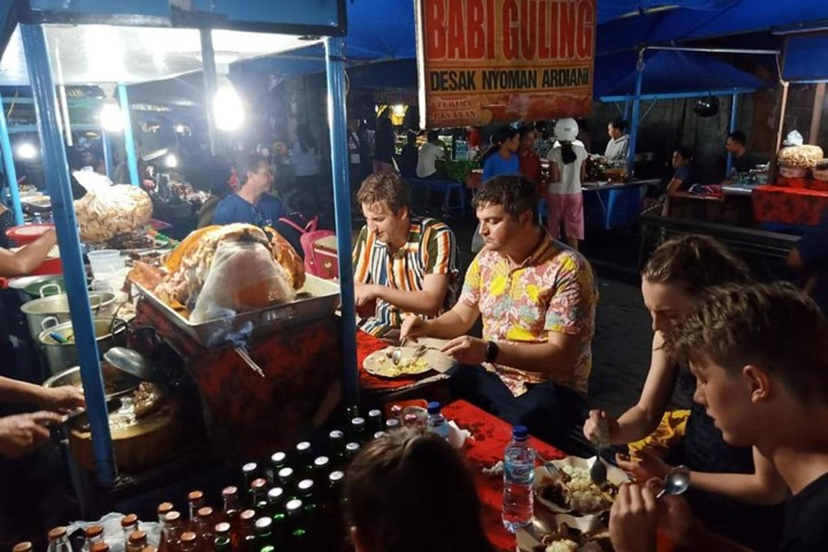 a group of people sitting around a table at a market