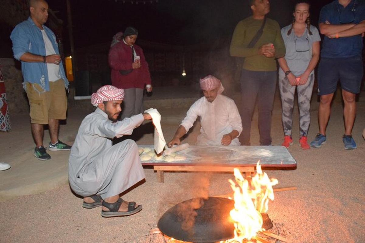 two men are cooking food over a fire
