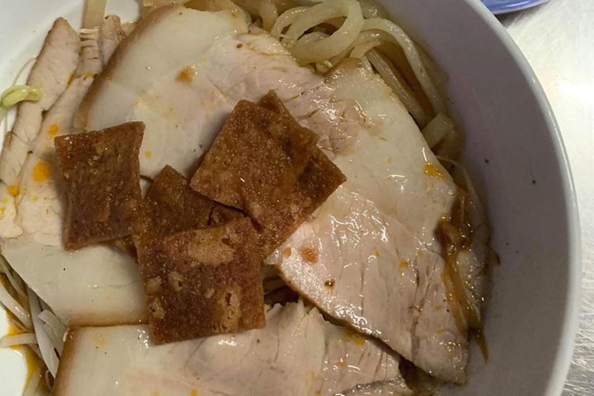 a bowl of food with meat and onions