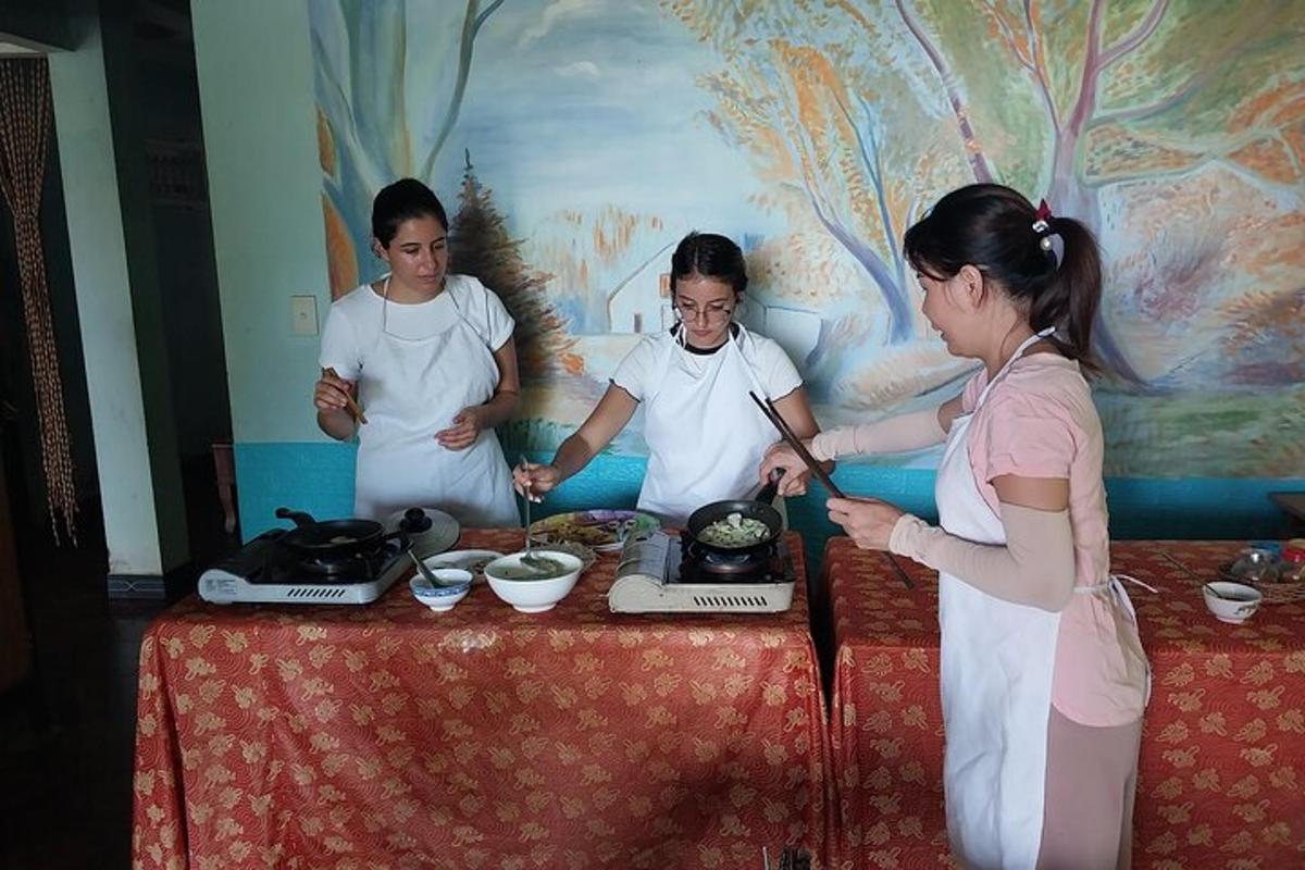 a group of women standing around a table with food