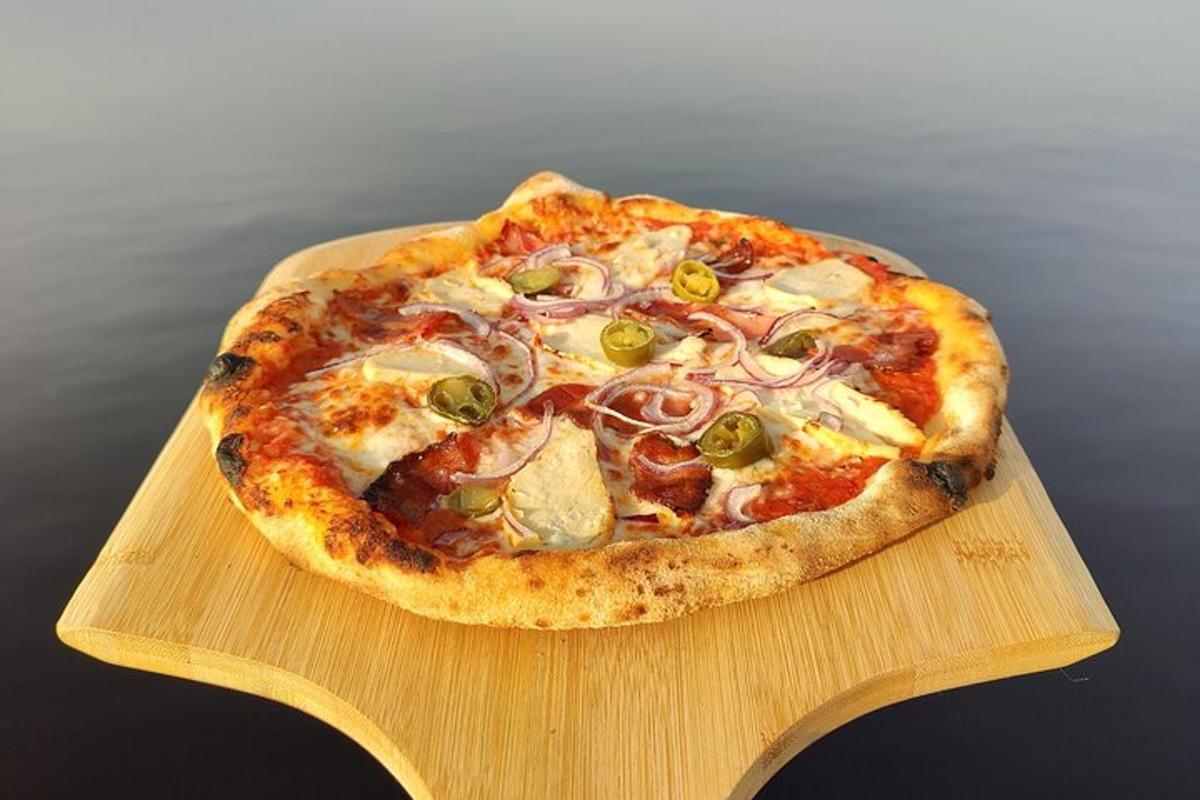 a pizza sitting on top of a wooden cutting board
