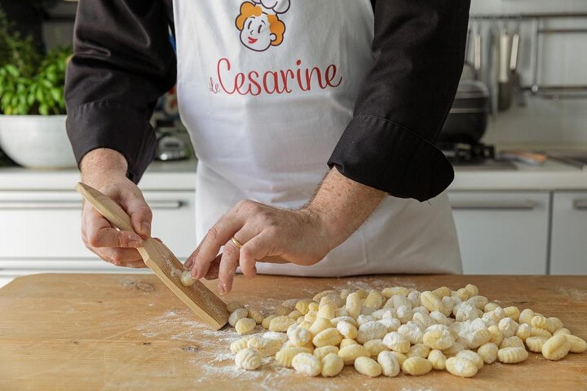 a man in a kitchen cutting up garlic on a cutting board