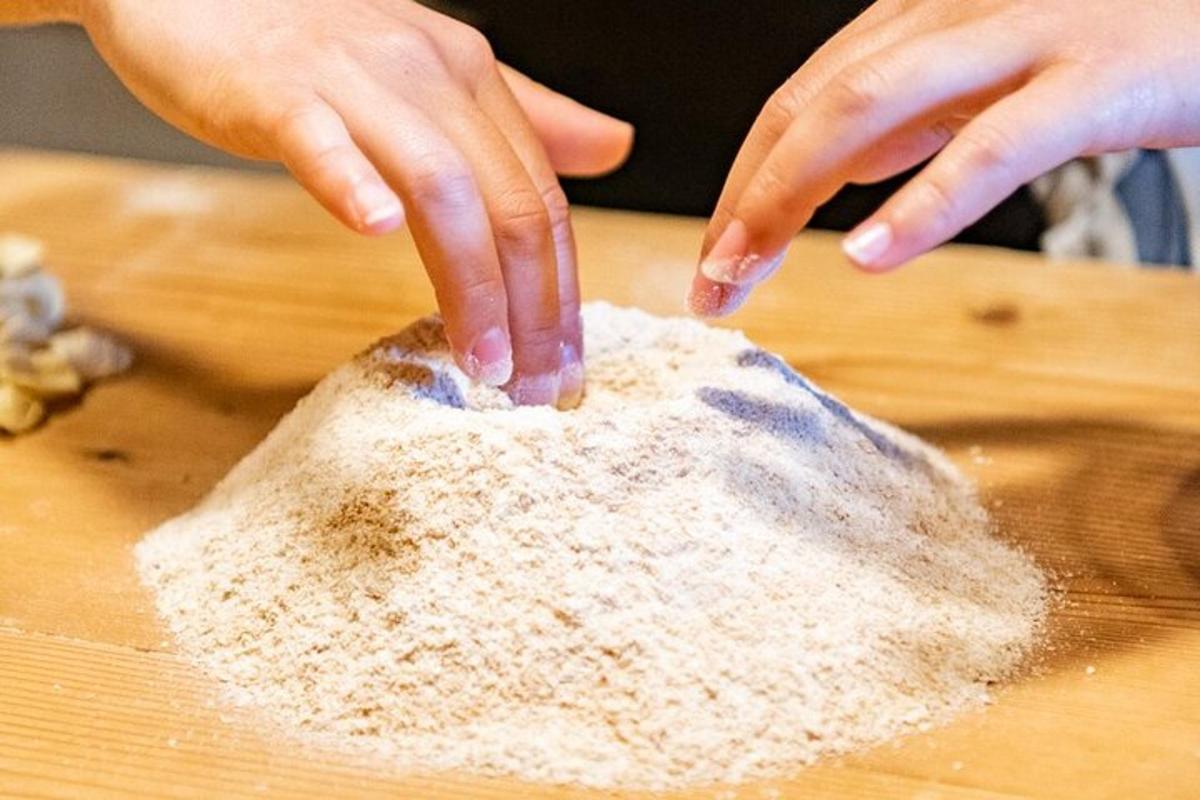 a person is mixing flour on a cutting board