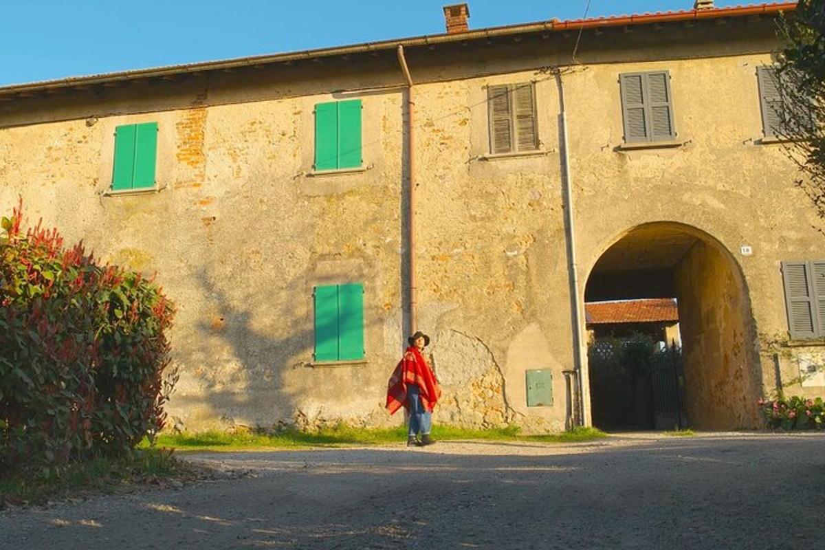 una donna che cammina davanti a un edificio con finestre verdi
