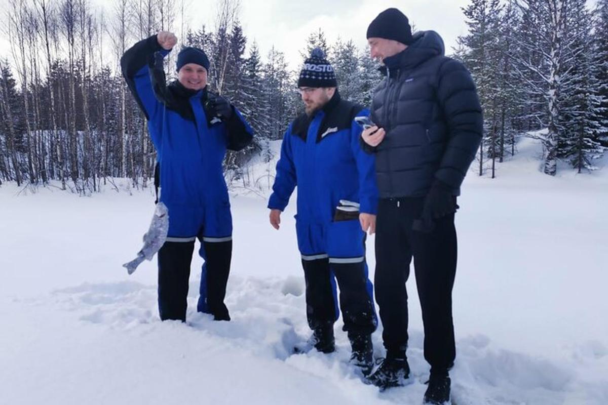 a group of three people standing in the snow