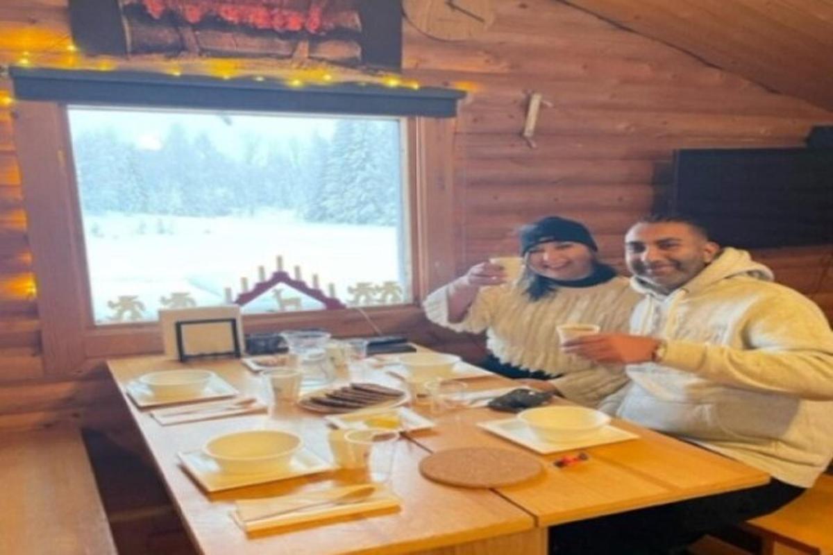 two people sitting at a table in a cabin