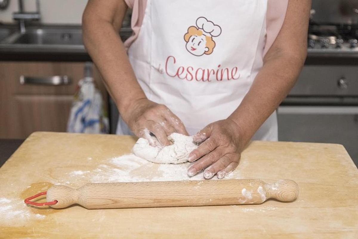 Una persona en una cocina amasando masa en una tabla de cortar.