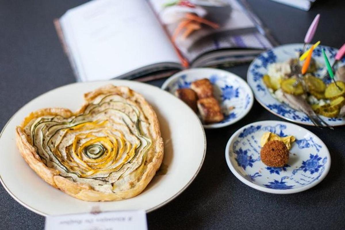 a plate with a heart shaped pastry on a table