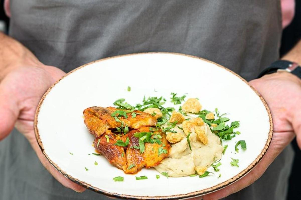a person holding a plate with food on it