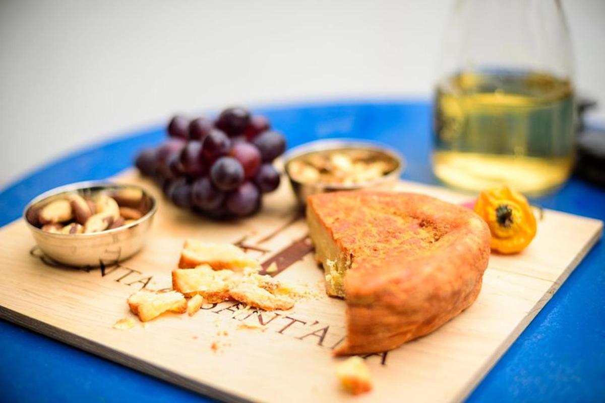 a cutting board with a piece of bread and grapes