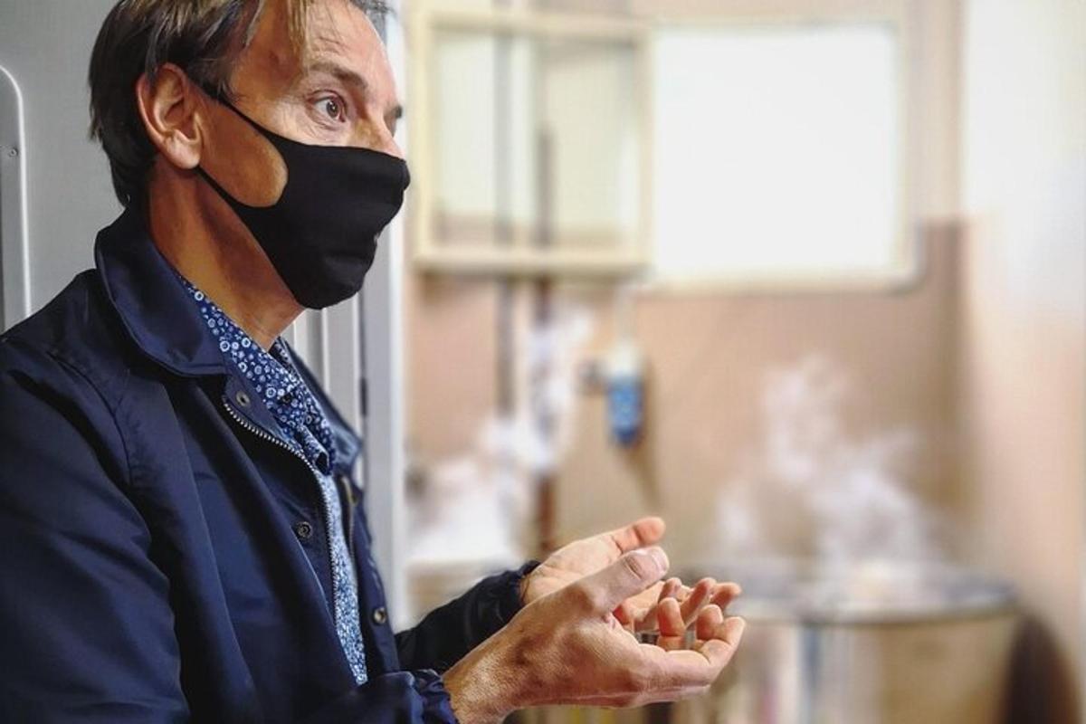 vyras su kauke ant veido meldžiasi