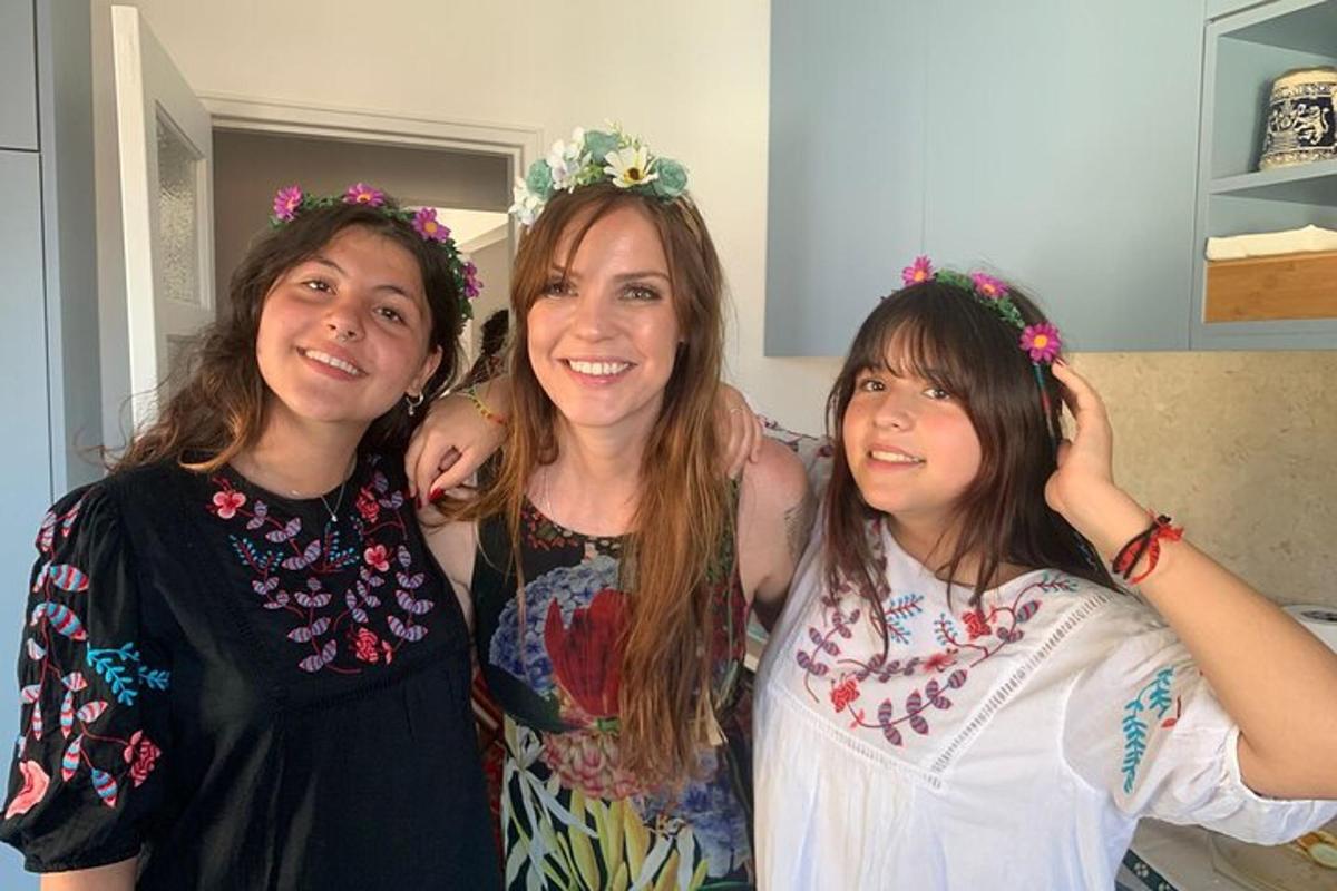 three women wearing flower crowns posing for a picture