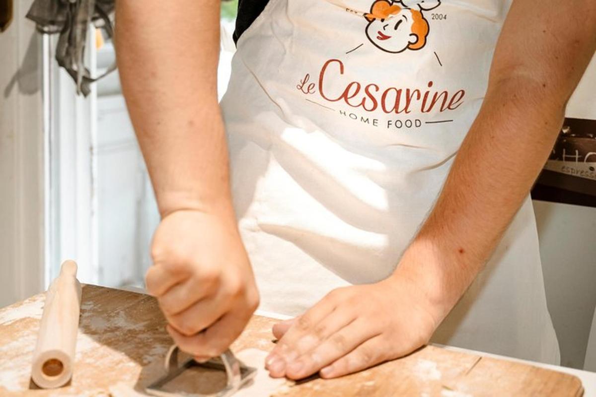 a person in a chefs apron preparing food on a cutting board