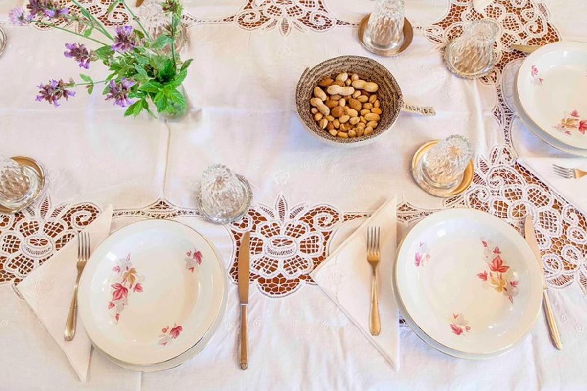 a white table with plates and forks and nuts