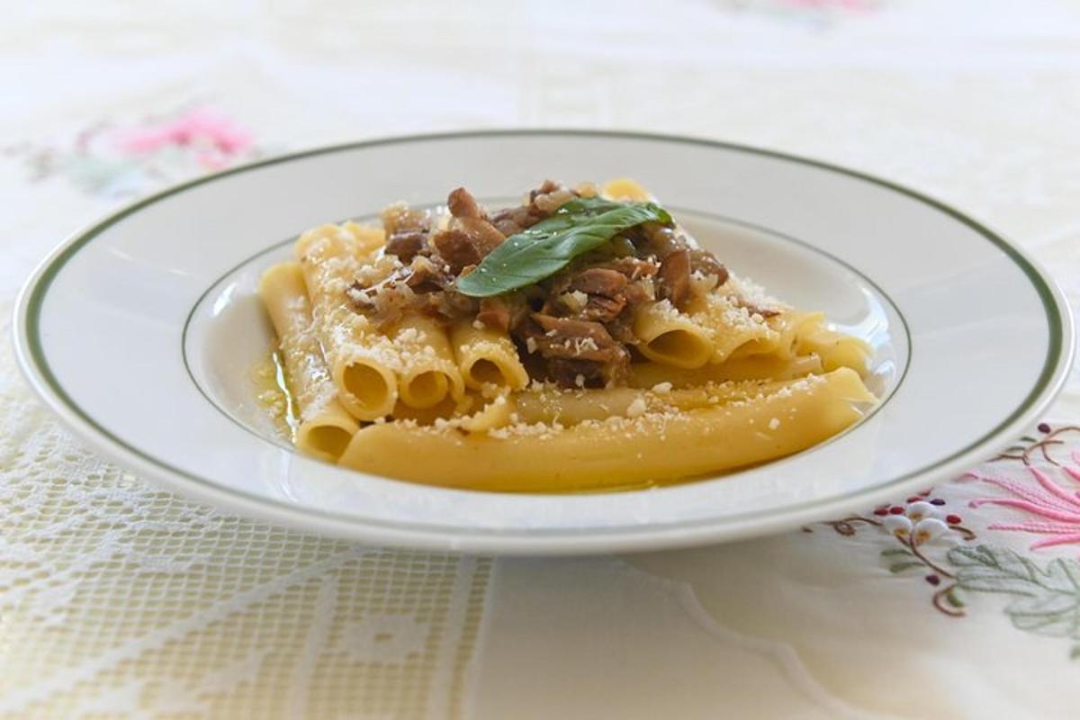 a plate of pasta with meat and sauce on a table