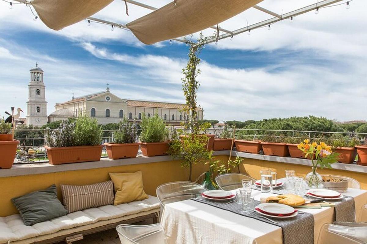 a balcony with tables and chairs and a view of a building