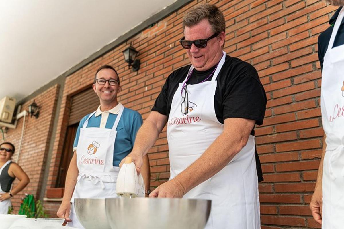 two men in a kitchen preparing food on a table