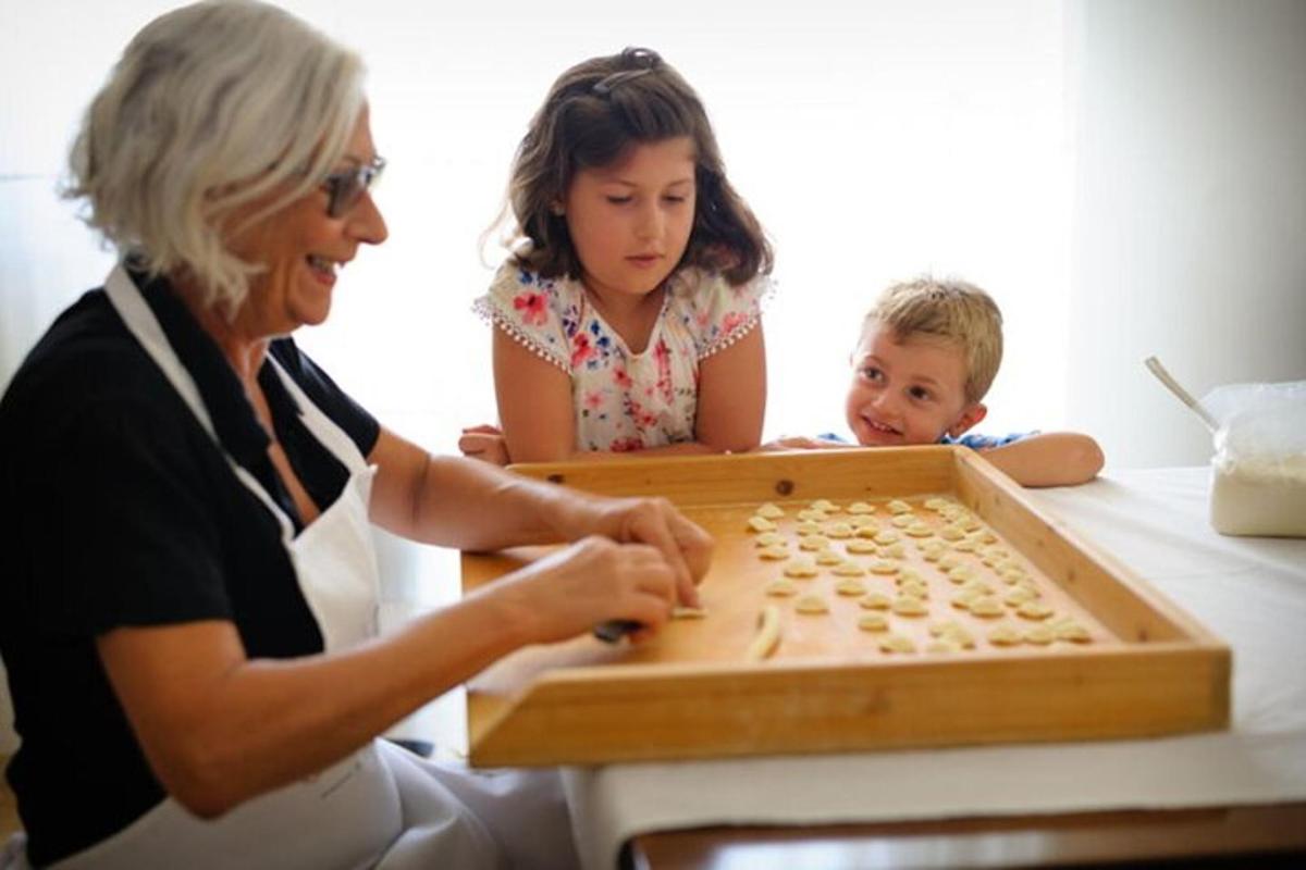 a woman and two children playing a board game