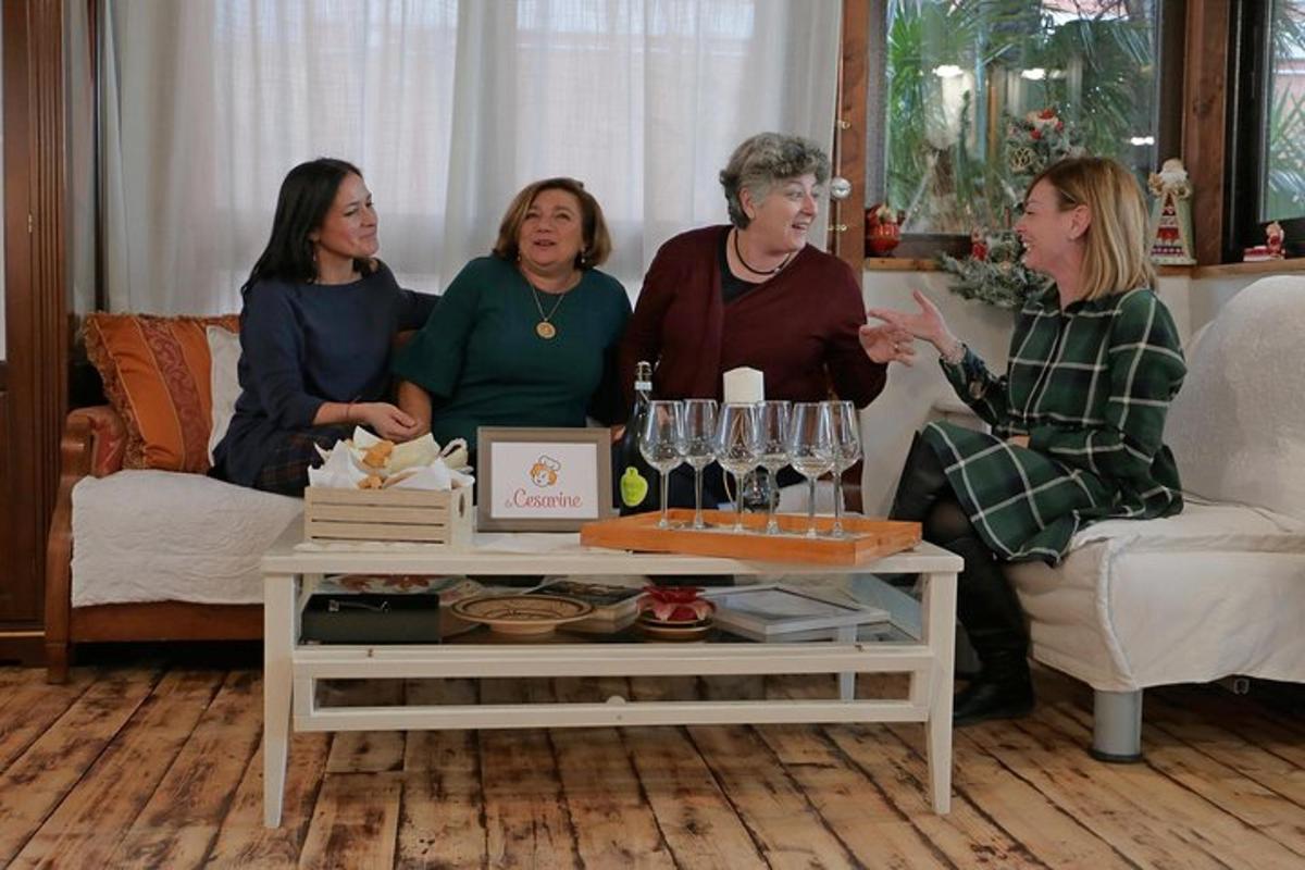 four women sitting on a couch in a living room
