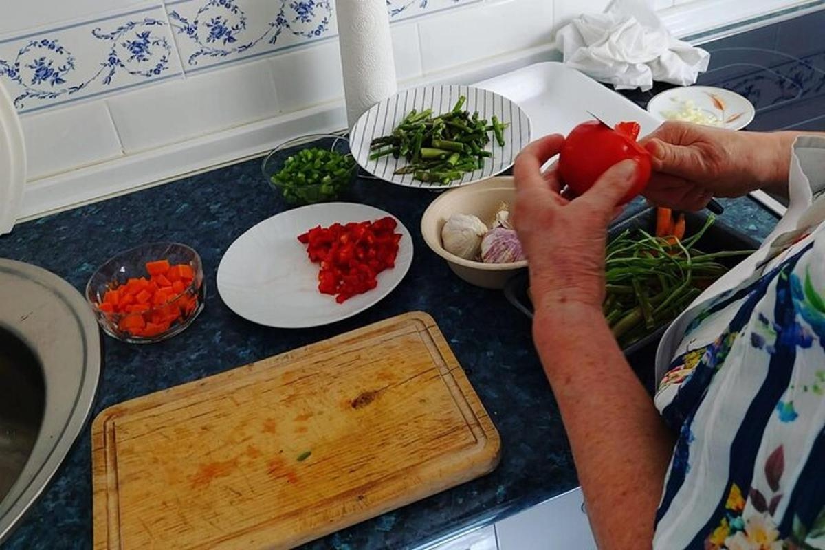 inimene, kes hoiab köögiletil tomatit