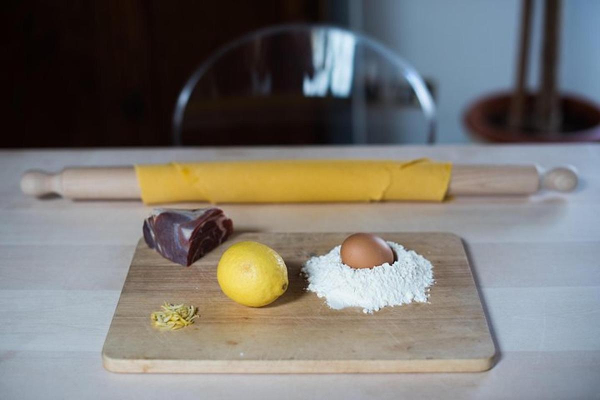 a wooden cutting board with an egg in a shell