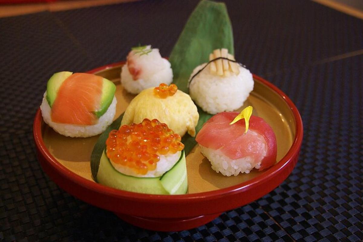 a red bowl filled with sushi on a table