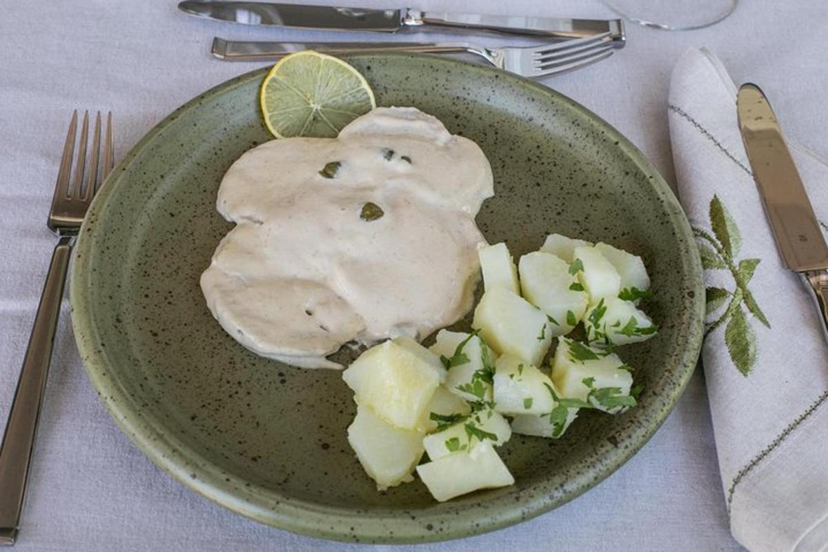 a plate of food with potatoes and a lemon slice