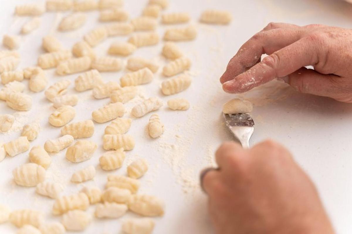 a person cutting up peanuts with a knife