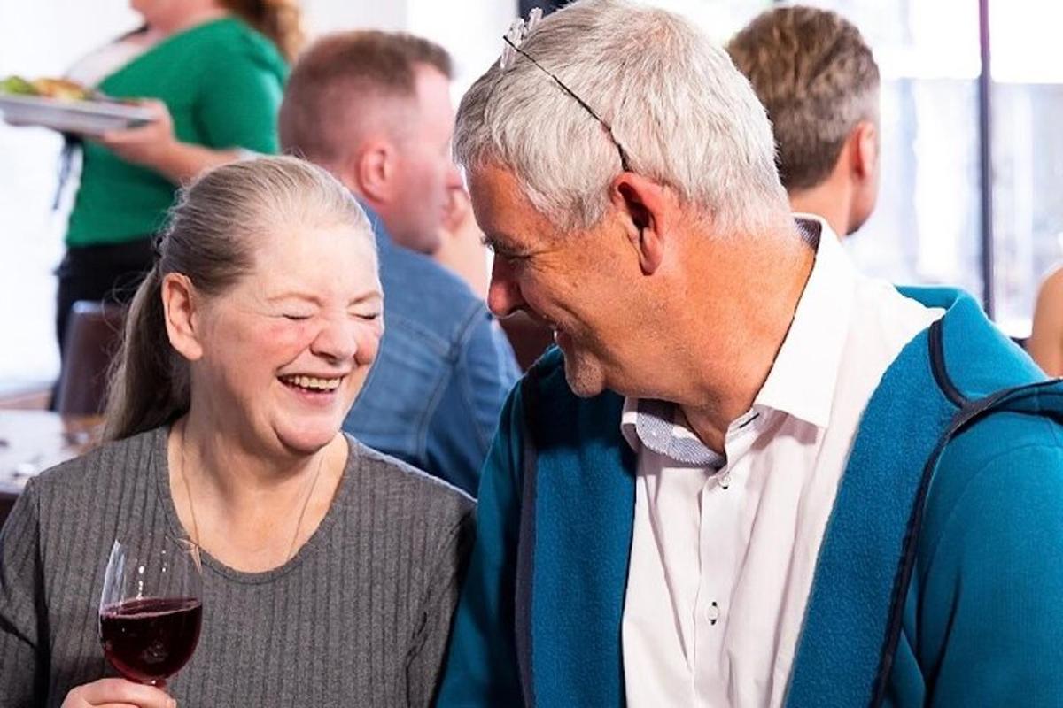 a man and a woman holding a glass of wine