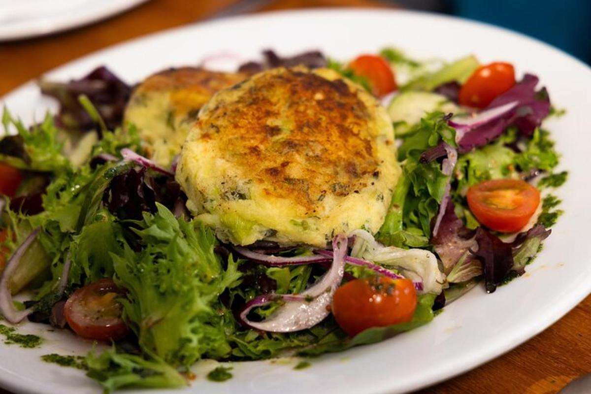 a plate of food with a salad and chicken on it