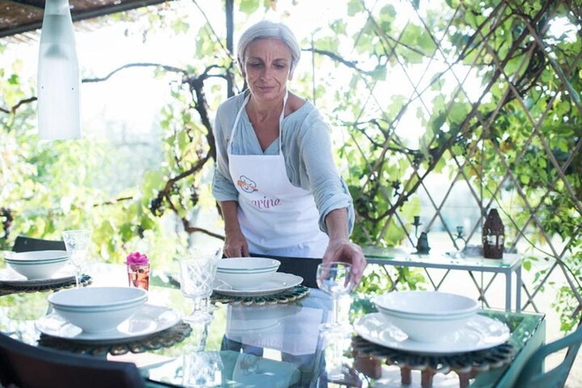 a woman standing in front of a table with dishes