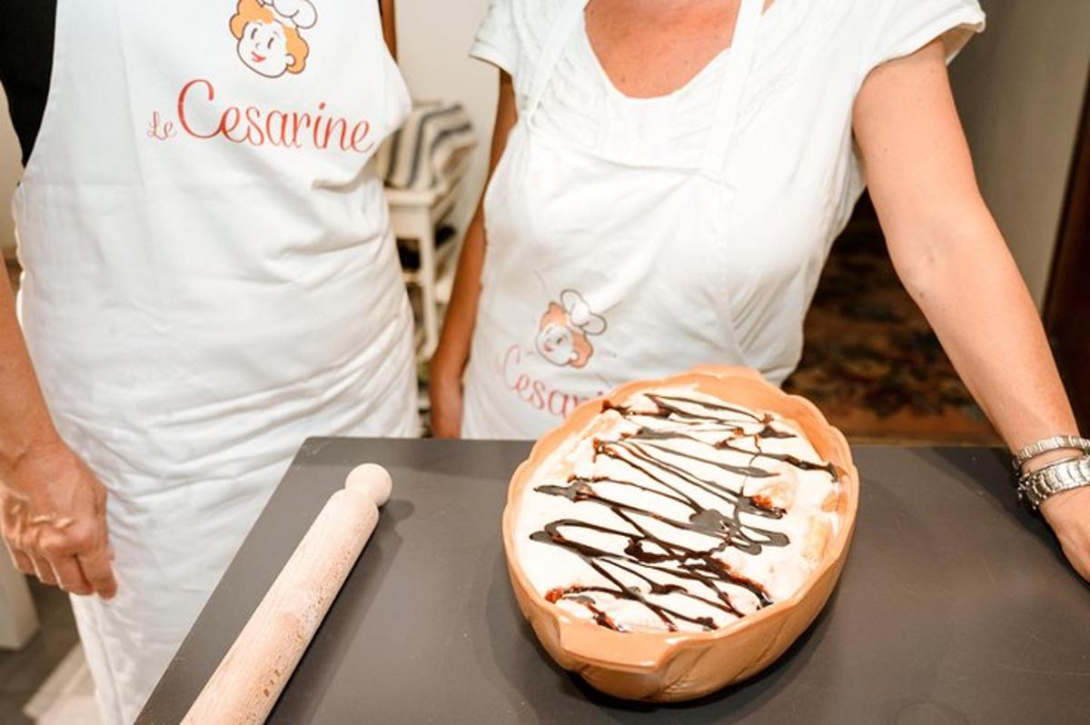 a woman is standing next to a cake on a table