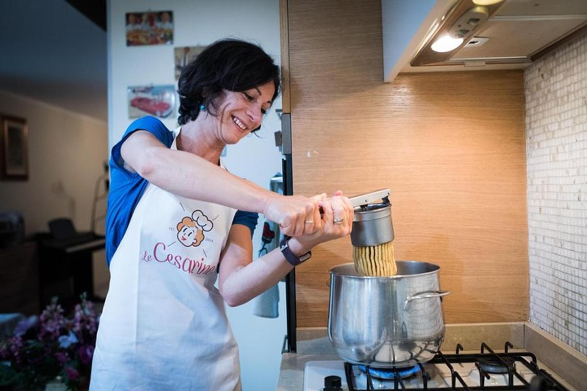 a woman in a kitchen preparing food in a blender