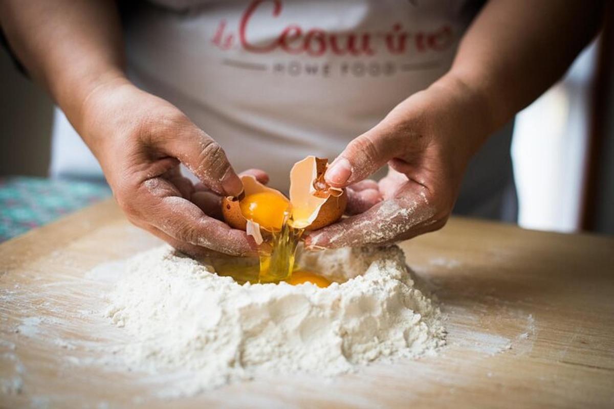 a person cutting up an egg into flour on a table