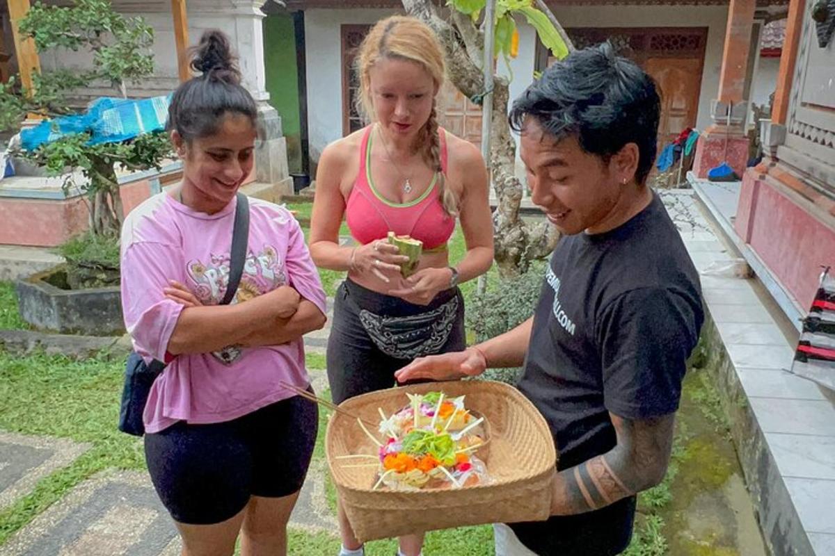 a group of three people looking at a cake