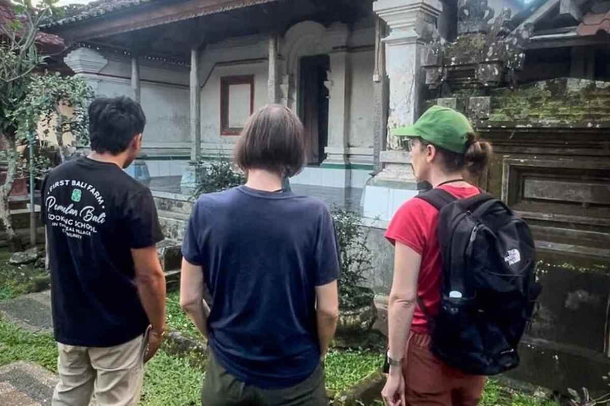 three people standing in front of a building