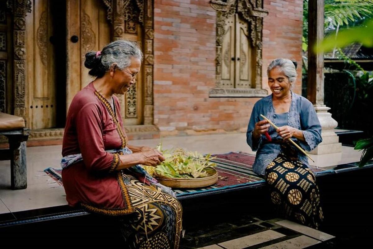 two older women sitting on a bench eating food